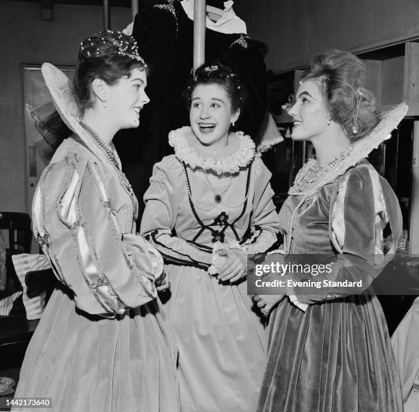 British actresses Rosemary Nicols, Noelle Finch and Caroline John in period costume during rehearsals for a play on November 24th, 1960.