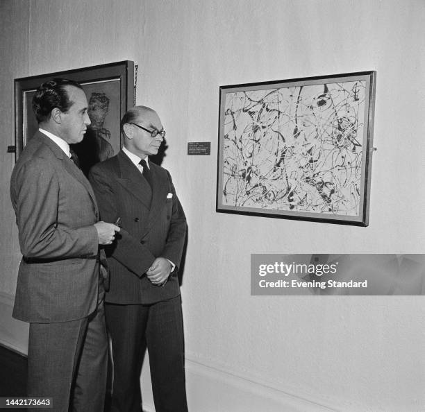 American entrepreneur Henry J Heinz II and Director of the Tate Gallery Sir John Rothenstein view 'Number 23', the Tate Gallery's first painting by...