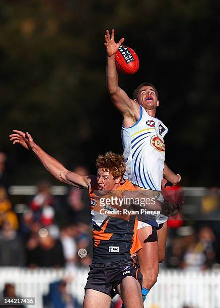 Zac Smith of the Suns wins a hit out over Andrew Phillips of the Giants during the round seven AFL match between the Greater Western Sydney Giants...