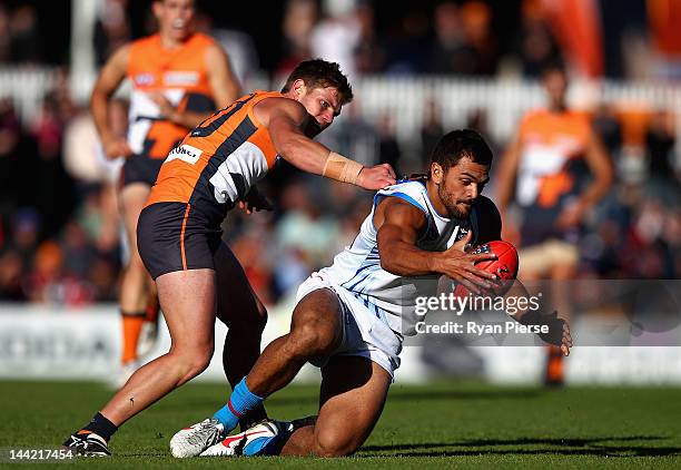 Taylor Adams of the Giants tackles Karmichael Hunt of the Suns during the round seven AFL match between the Greater Western Sydney Giants and the...