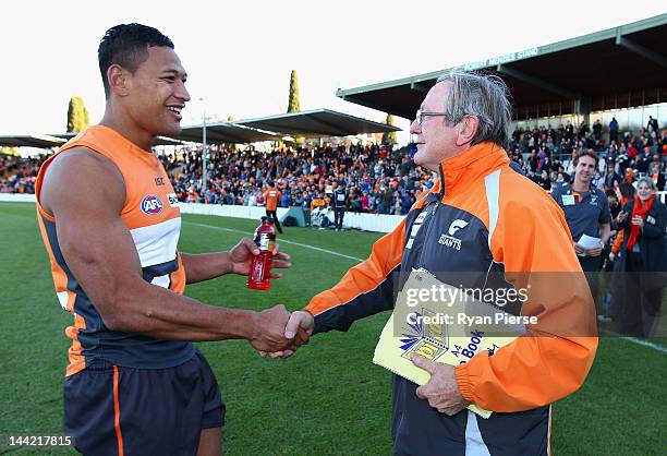 Kevin Sheedy, coach of the Giants and Israel Folau of the Giants celebrates the Giants first AFL victory after the round seven AFL match between the...