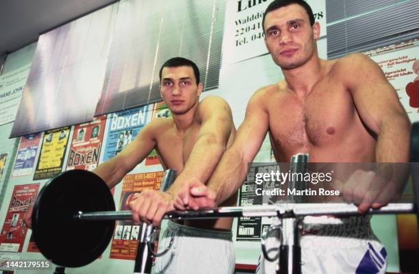 Ukrainian boxer Wladimir Klitschko and his brother, Ukrainian boxer Vitali Klitschko, pose in shorts behind a barbell in an gym in Hamburg, Germany,...