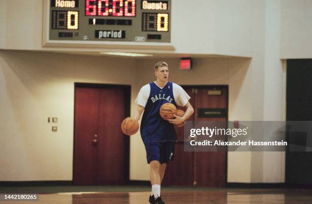 German basketball player Dirk Nowitzki holding three Spalding basketballs in his arms during a Dallas Mavericks training session at the Reunion Arena...