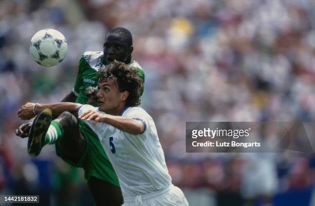 Nigerian footballer Rashidi Yekini and Italian footballer Paolo Maldini challenge for the ball in the Round of 16 match between Nigeria and Italy at...
