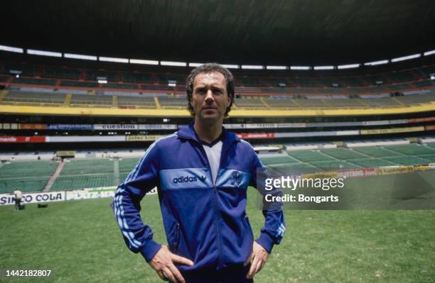 German football manager and former footballer Franz Beckenbauer, manager of the West Germany national team, wearing a blue adidas tracksuit, in the...