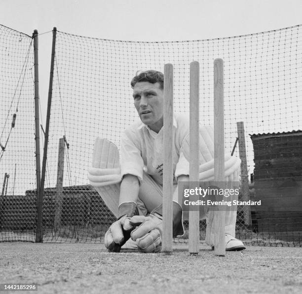 English cricketer Brian Taylor , of Essex County cricket club, squatting behind the stumps during training on April 19th, 1961.