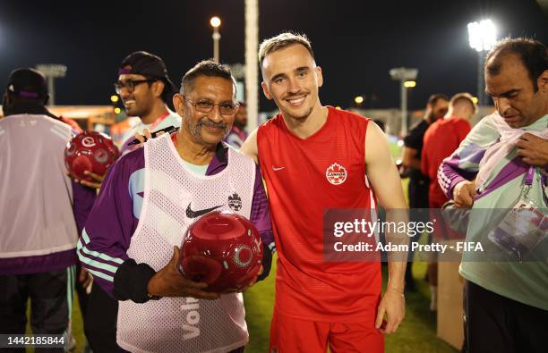 Liam Millar of Canada signs autographs for FIFA volunteers during the FIFA Community Engagement Event with Canada on November 14, 2022 in Doha, Qatar.