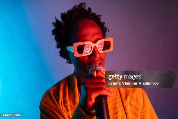 happy african man singing - music artist stock pictures, royalty-free photos & images