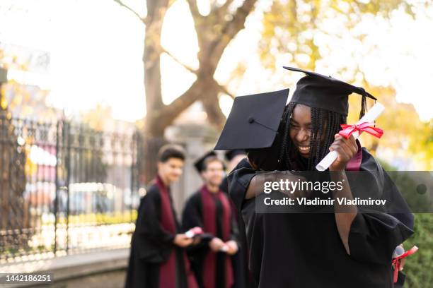 young student is embracing each other after the graduating ceremony - graduation excitement stock pictures, royalty-free photos & images