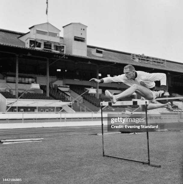 American hurdler Paul Herman jumping a hurdle during training ahead of the Great Britain v USA athletics meeting at White City Stadium in London on...