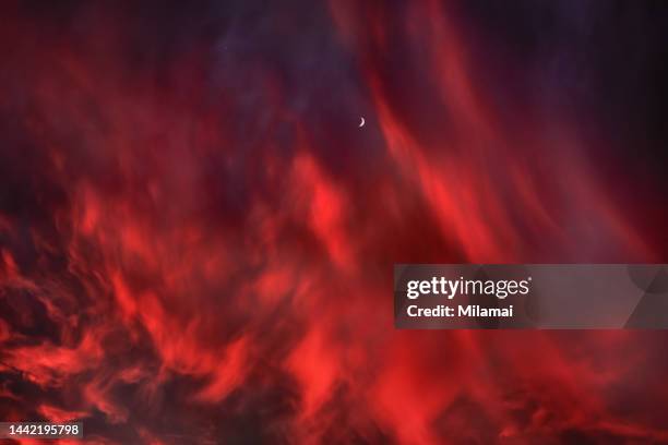 red clouds glowing in the dark. long exposure. helsinki, finland. europe. - romantic sunset stock-fotos und bilder