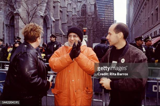 American playwright and activist Larry Kramer applauds in front of a police barricade during an ACT UP protest in front of St Patrick's Cathedral,...