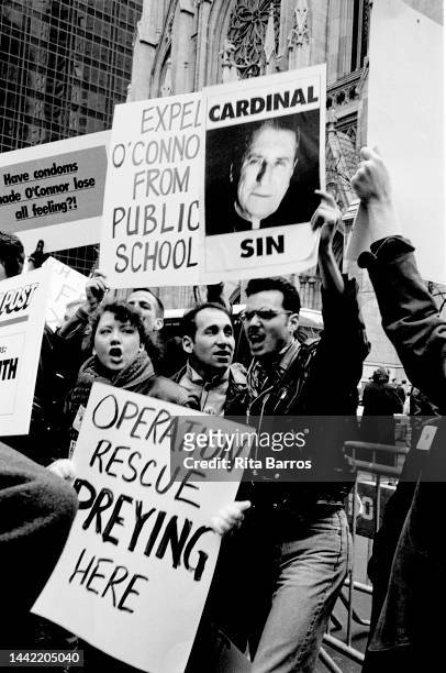 View of demonstrators, many holding signs, during an ACT UP protest in front of St Patrick's Cathedral, New York, New York, December 1, 1990. Among...