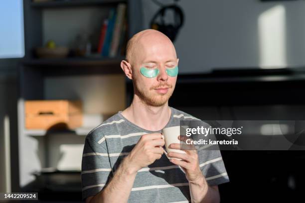 bald man with eye patches drinking coffee - coffee moustache stock pictures, royalty-free photos & images