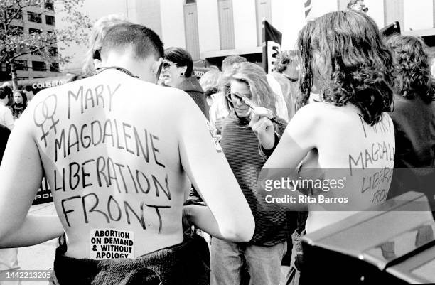 View, from behind, of two shirtless protesters during a protest against Operation Rescue , organized by WHAM , New York, New York, October 18, 1992....