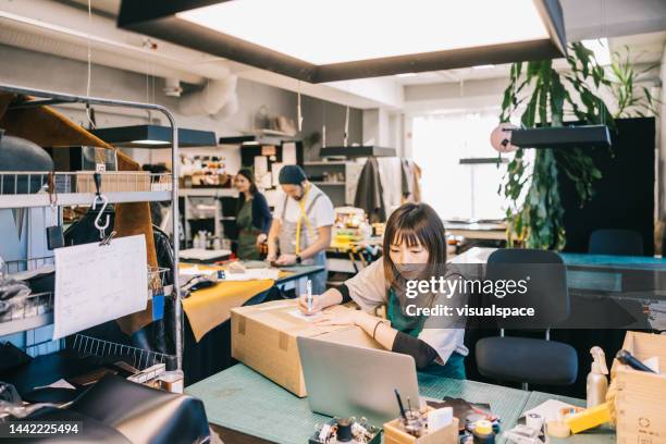 japanese business owner sending package to customer - leather craft stock pictures, royalty-free photos & images