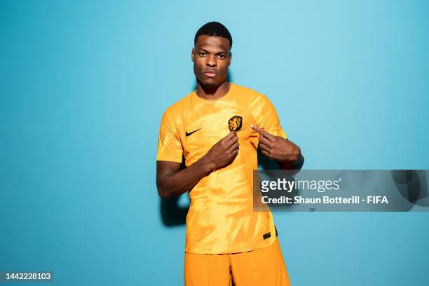 Denzel Dumfries of Netherlands poses during the official FIFA World Cup Qatar 2022 portrait session at on November 16, 2022 in Doha, Qatar.