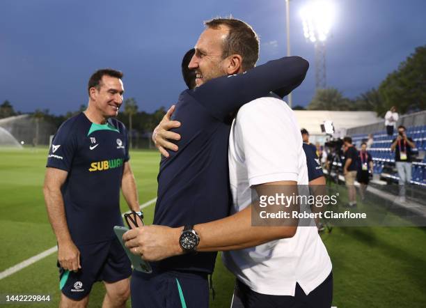 Former Socceroo Tim Cahill greets former team mate Mark Schwarzer during the Australia training session at the Aspire Training Ground on November 17,...