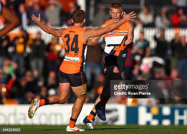 Adam Treloar of the Giants celebrate a goal during the round seven AFL match between the Greater Western Sydney Giants and the Gold Coast Suns at...