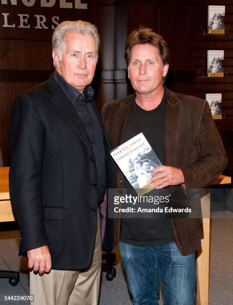 Actors Martin Sheen and Emilio Estevez pose before signing copies of their book "Along The Way" at Barnes & Noble bookstore at The Grove on May 11,...