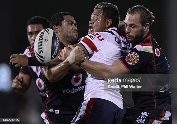 Joseph Leilua of the Roosters looses the ball in the tackle of Simon Mannering of the Warriors during the round 10 NRL match between the New Zealand...