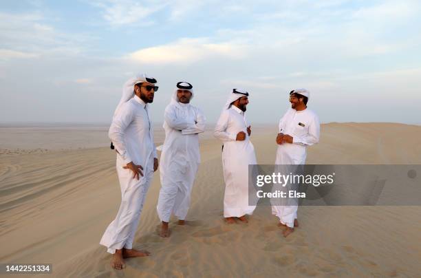 Desert sand dune drivers are seen in the desert as patrons are viewing the setting sun ahead of the FIFA World Cup Qatar 2022 at on November 17, 2022...