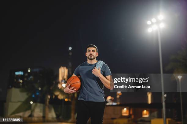 middle eastern male athlete after a game holding a towel in dubai - sportman stock pictures, royalty-free photos & images