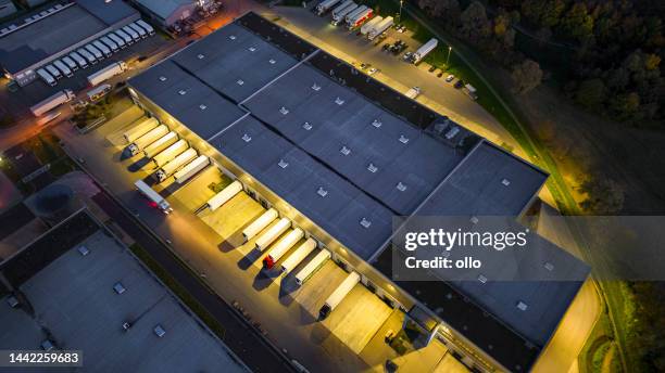 distribution warehouse at dusk - aerial view - transportation hub stock pictures, royalty-free photos & images
