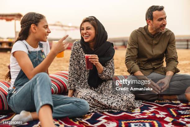 middle eastern family having a lovely picnic in the desert in dubai - burka stock pictures, royalty-free photos & images