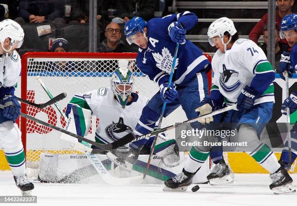 Mitchell Marner of the Toronto Maple Leafs skates against Spencer Martin of the Vancouver Canucks at the Scotiabank Arena on November 12, 2022 in...