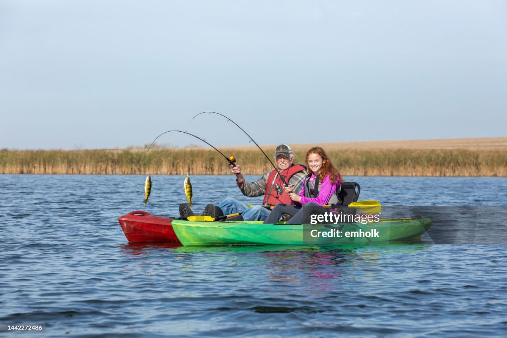 Grandfather & Granddaughter Kayak Fishing