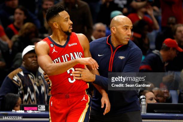 New Orleans Pelicans assistant coach Fred Vinson restrains CJ McCollum of the New Orleans Pelicans after he recieved a technical foul during the...