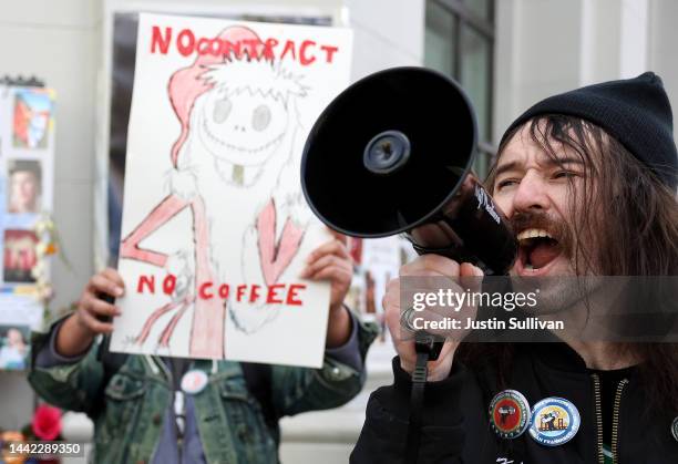Striking Starbucks worker Kyle Trainer uses a megaphone outside of a Starbucks coffee shop during a national strike on November 17, 2022 in San...