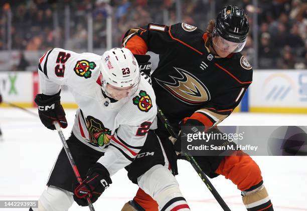 Philipp Kurashev of the Chicago Blackhawks battles Trevor Zegras of the Anaheim Ducks during the first period of a game at Honda Center on November...