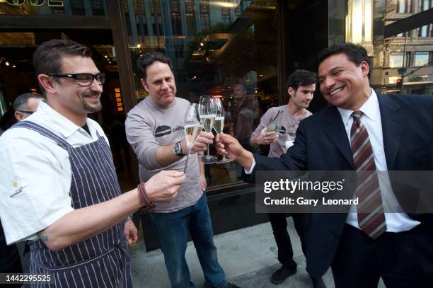 On Broadway City Council Member José Huizar clinks champagne glasses with the owner and chef of Umami Burger to celebrate the grand opening on April...