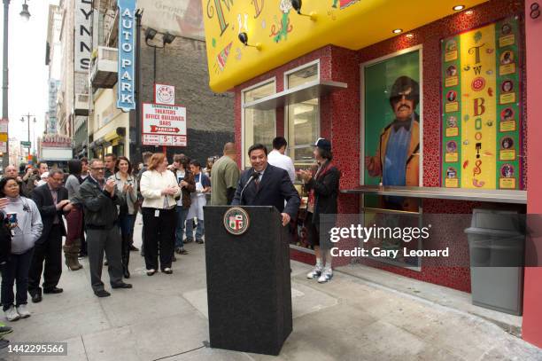 On Broadway outside Two Boots pizza a small crowd applauds as City Council Member José Huizar speaks at a podium during the grand opening on May 2,...