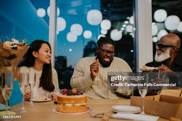 colleagues enjoy an after-work office party - party prop stock pictures, royalty-free photos & images