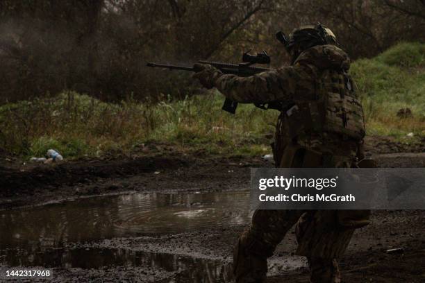 Member of the Foreign Legion fires on a Russian position from the bank of the Dnipro River during a small incursion operation on November 17, 2022 in...