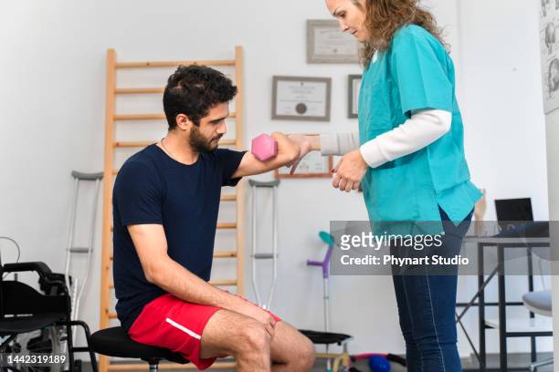 man with amputated arm exercising with dumbbell - athlete montage stock pictures, royalty-free photos & images
