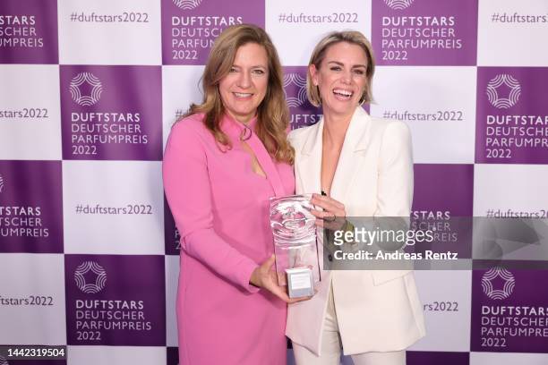 Yvonne Rostock and laudatio Sandra Kuhn pose with the award during the Duftstars 2022 on November 17, 2022 in Cologne, Germany.