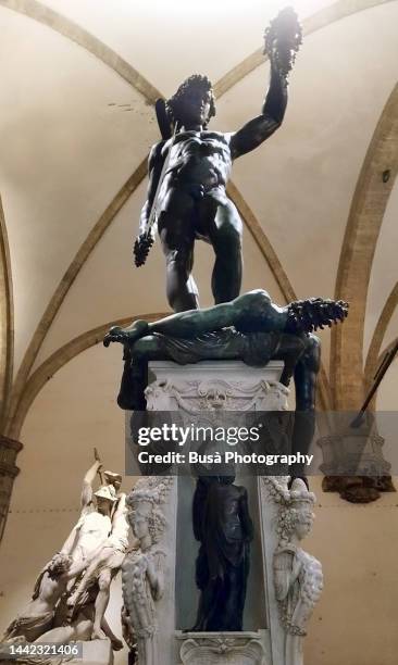 bronze statue of perseus with the head of medusa by benvenuto cellini in the loggia dei lanzi or loggia della signoria, in piazza della signoria in florence, ita - loggia dei lanzi stock pictures, royalty-free photos & images