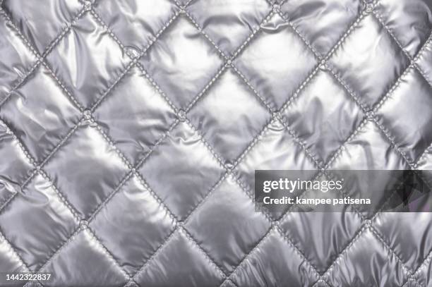 quilted cloth, full frame shot of sivler fabric. - silberner mantel stock-fotos und bilder