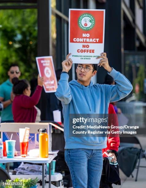 Anaheim, CA A worker carries a strike sign outside of a unionized Starbucks Coffee on Katella Avenue in Anaheim, as he joins fellow workers and those...