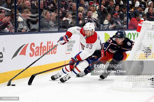 Evgenii Dadonov of the Montreal Canadiens controls the puck against Jake Christiansen of the Columbus Blue Jackets during the first period at...