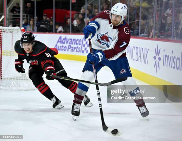 Martin Necas of the Carolina Hurricanes defends Devon Toews of the Colorado Avalanche during the first period of their game at PNC Arena on November...