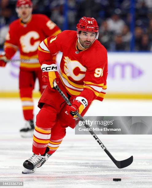 Nazem Kadri of the Calgary Flames looks to pass during a game against the Tampa Bay Lightning at Amalie Arena on November 17, 2022 in Tampa, Florida.