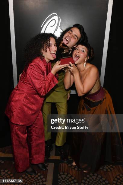 Julia Mestre, Zé Ibarra and Dora Morelenbaum of Bala Desejo pose backstage with the award for Contemporary Pop Album in Portuguese Language for their...