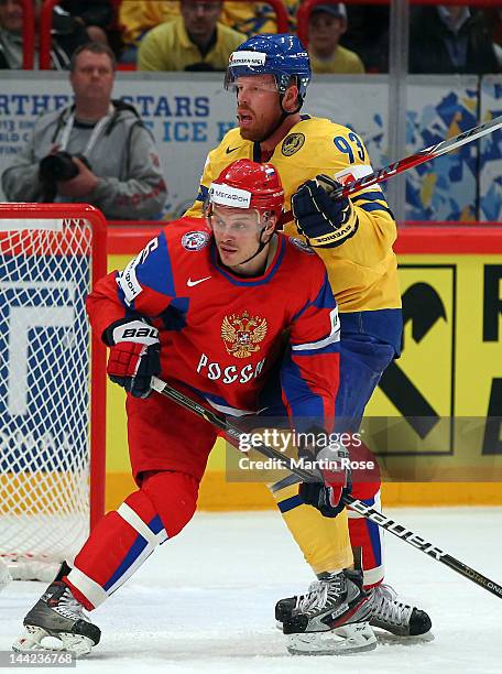 Denis Denisov of Russia battles for position with Johan Franzen of Sweden during the IIHF World Championship group S match between Russia and Sweden...