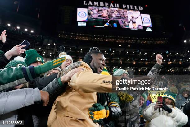 Hall of Famer LeRoy Butler celebrates with fans on the field during halftime in the game between the Tennessee Titans and the Green Bay Packers at...