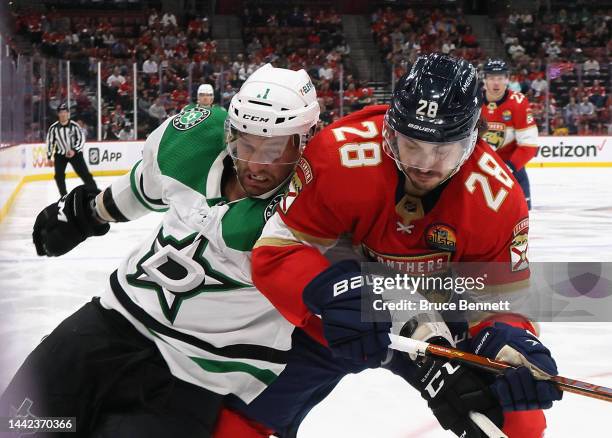 Luke Glendening of the Dallas Stars is held back by Josh Mahura of the Florida Panthers during the third period at FLA Live Arena on November 17,...